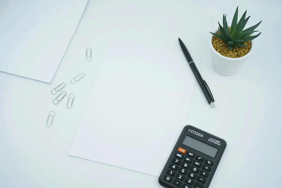 A calculator and pen on a sheet of paper