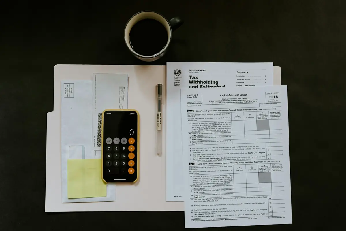 Household paperwork, a pen and a phone calculator on a folder