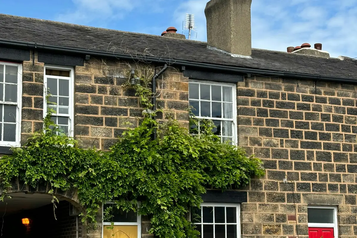 A brick house with a yellow front door