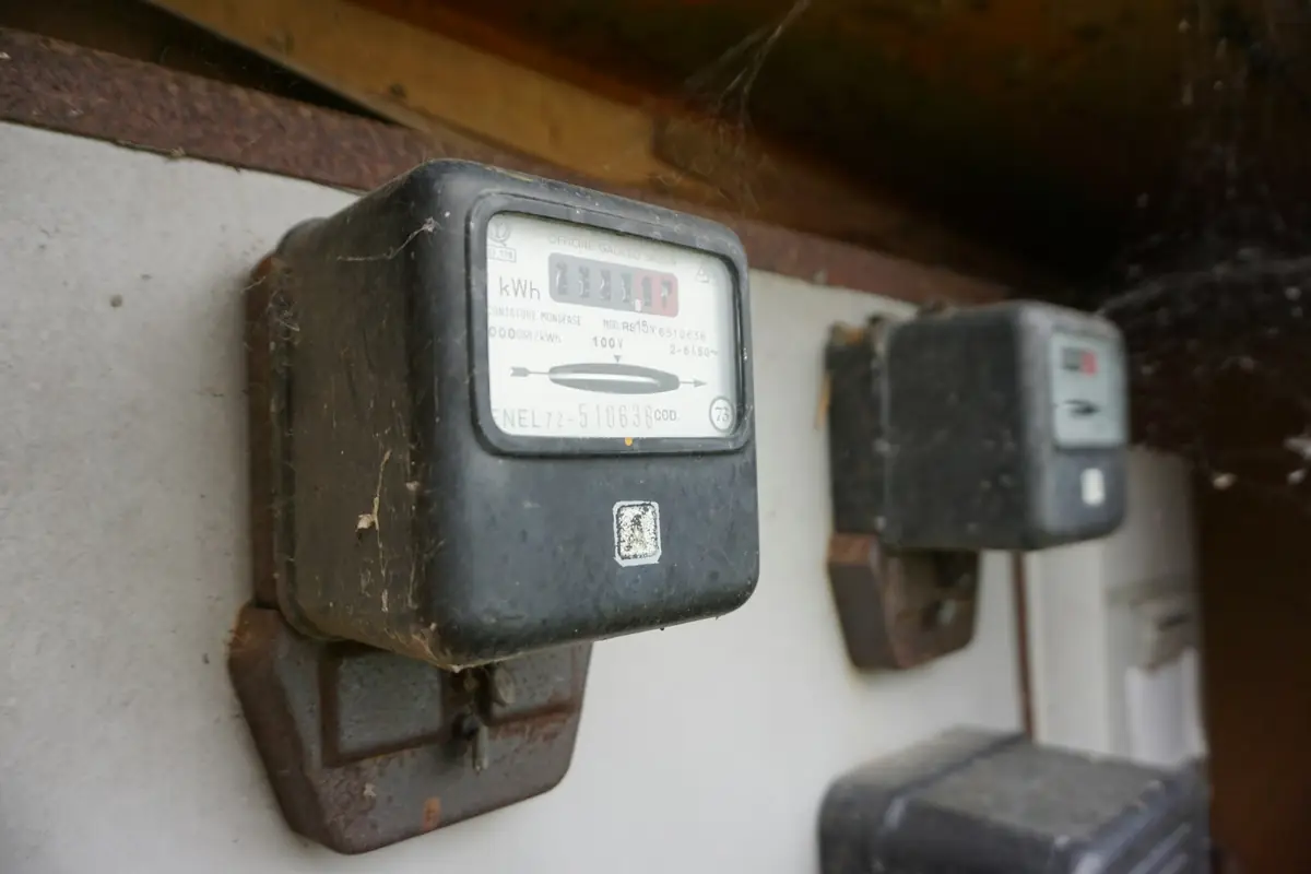Two old electricity meters mounted on a wall
