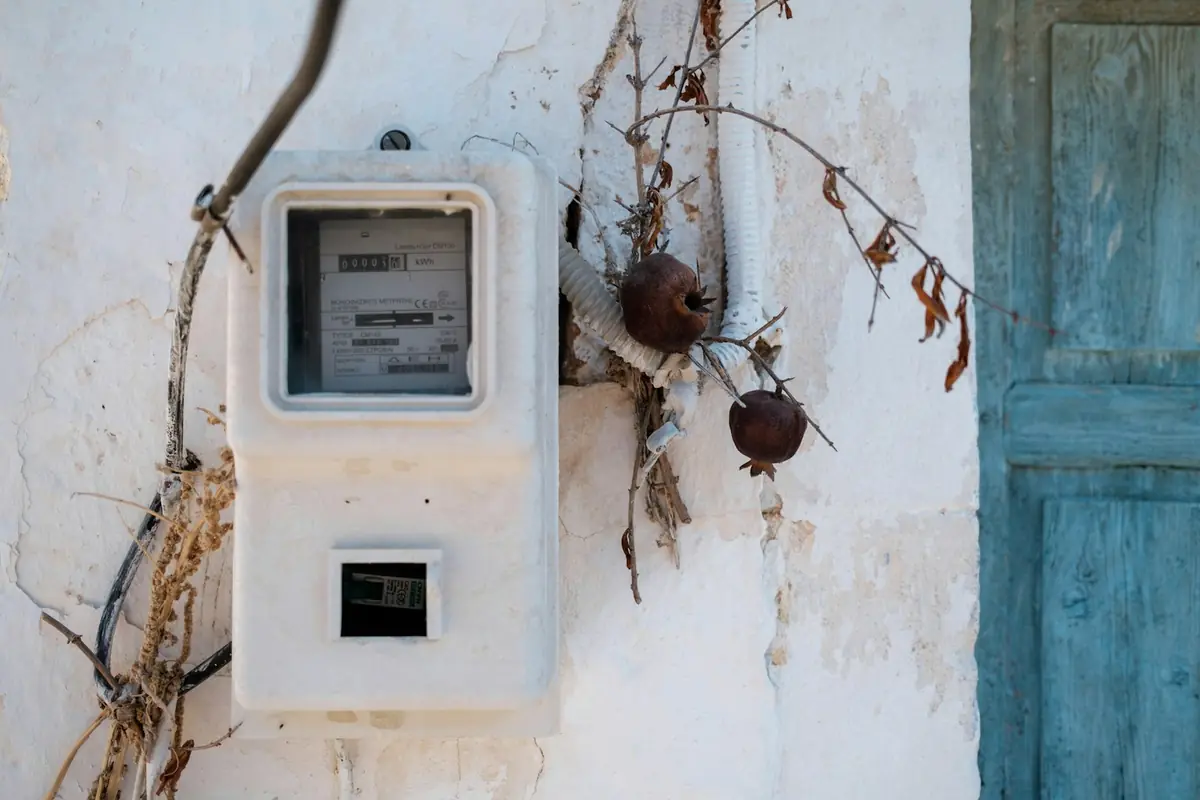 An electricity meter on a textured wall