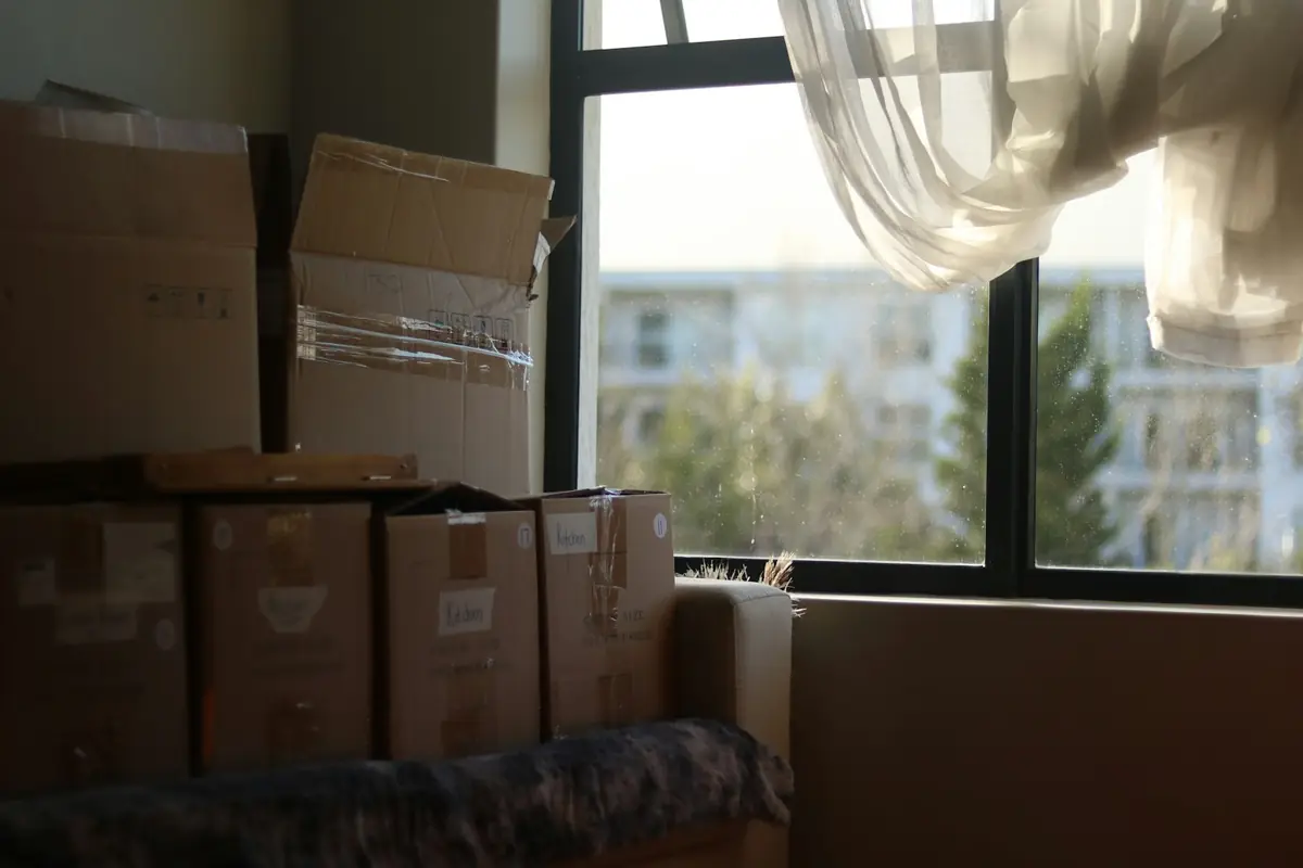 Moving boxes stacked in an empty room