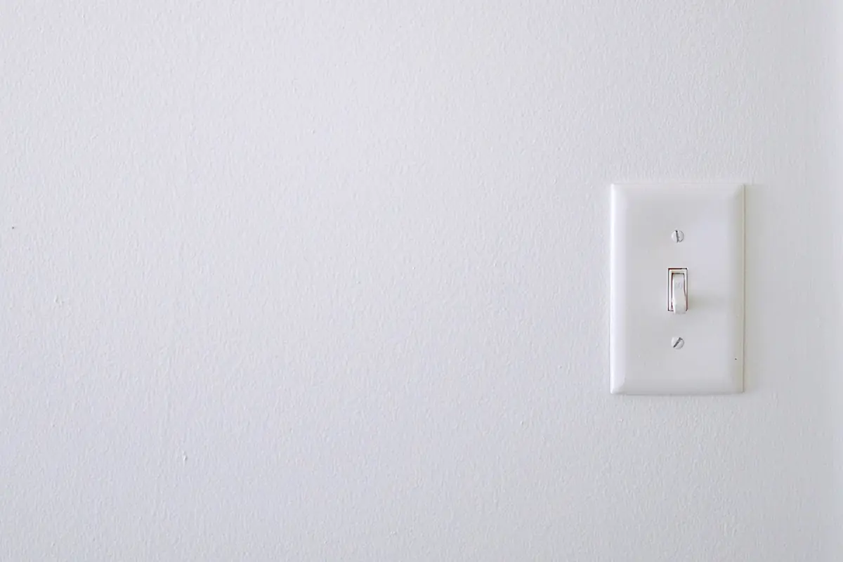A white light switch on a wall
