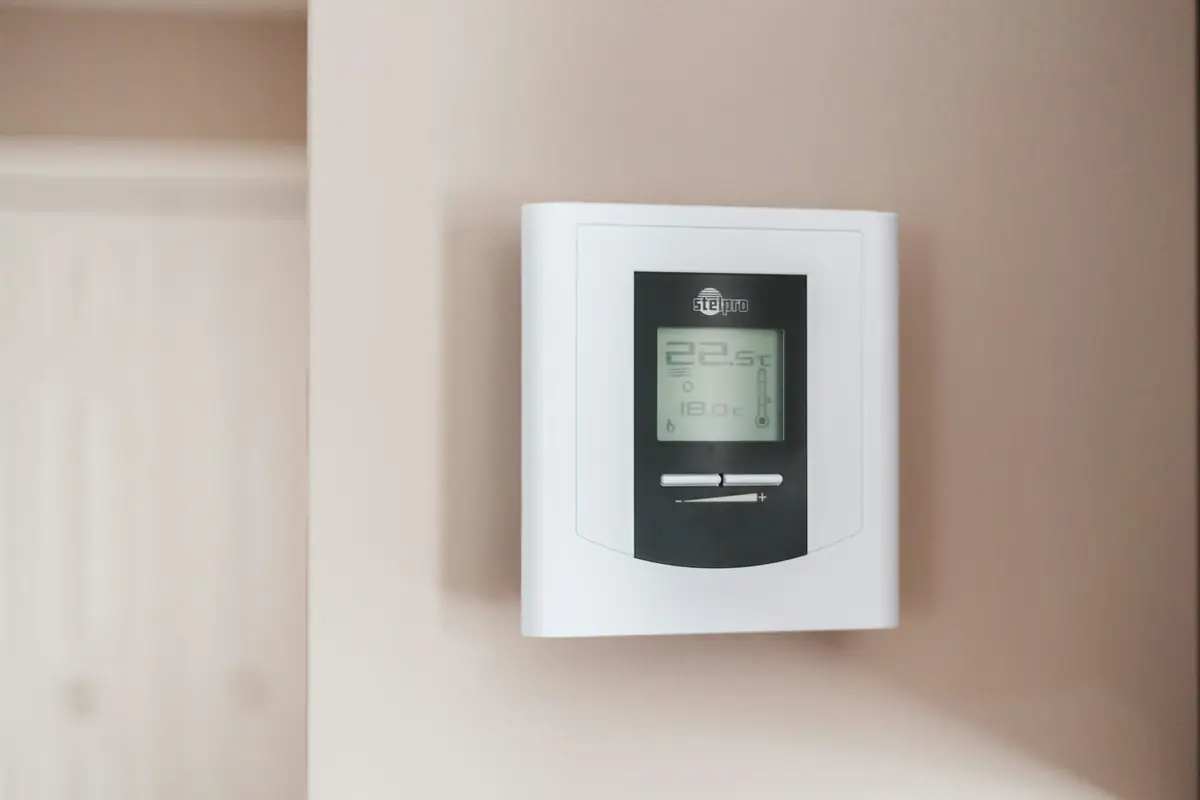 A wall thermostat showing 19.5 degrees